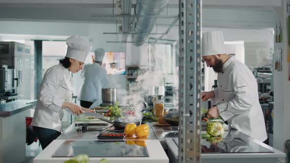 Team of Cooks Preparing Fresh Ingredients to Follow Culinary Recipe alt