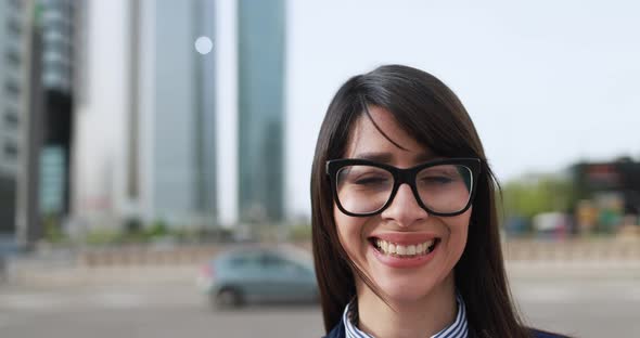 Business woman working outside of the office with city in background alt