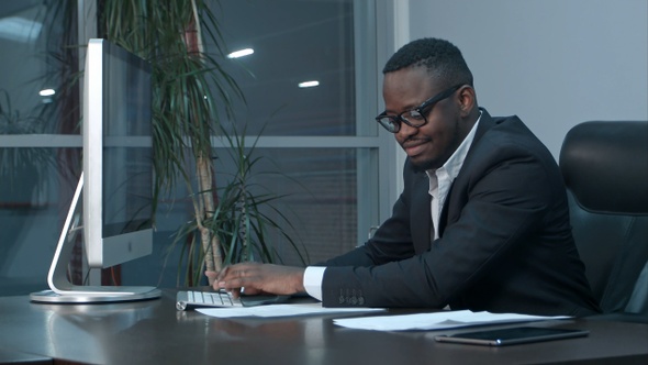 Successful African American Businessman Sitting at Desk