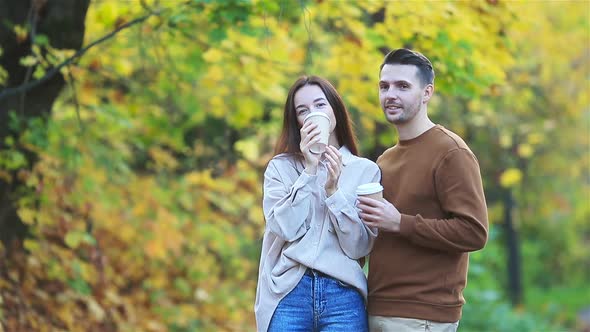 Happy Family Walking in Autumn Park on Sunny Fall Day alt