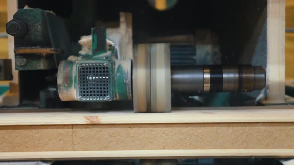 Machine Makes Grooves in Wooden Beam in Carpentry Workshop alt