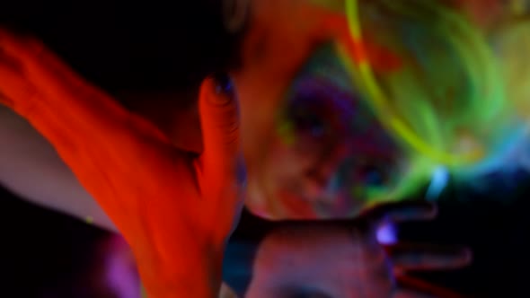 Mysterious Woman with Fluorescent Paints on Face and Body Extravagant Image for Actress alt