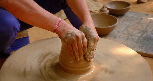 Pottery - Skilled Wet Hands of Potter Shaping the Clay on Potter Wheel. Pot, Vase Throwing alt