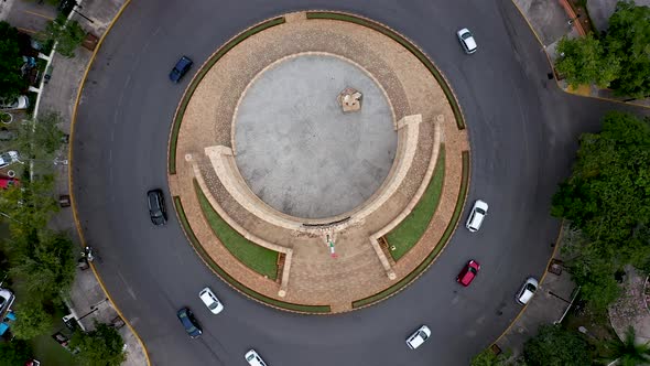 Aerial ascent looking straight down on the Monument a la Patria, Homeland Monument and traffic circl alt