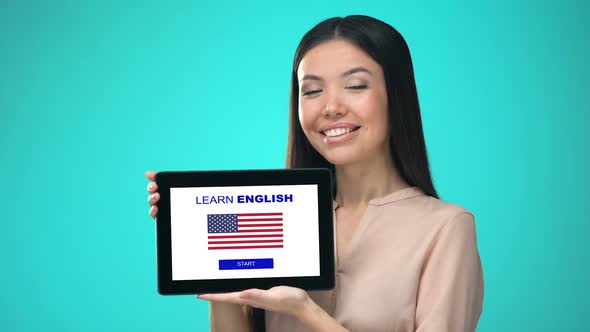 Female Holding Tablet With Learn American English Application, Ready to Start alt