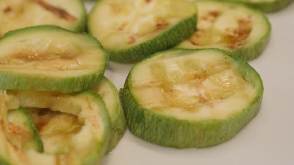 Grilled Pepo cylindrica slices close-up 4K 2160p 30fps UltraHD panning footage - Tasty  zucchini on  alt