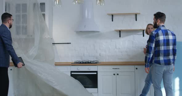 Real Estate Agent Showing Property To a Couple alt