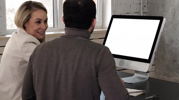Two Young Businessman Having a Meeting at Office Looking in Monitor. White Display alt