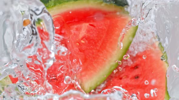 Super Slow Motion Shot of Melon Slices Falling Into Water Whirl at 1000 Fps alt