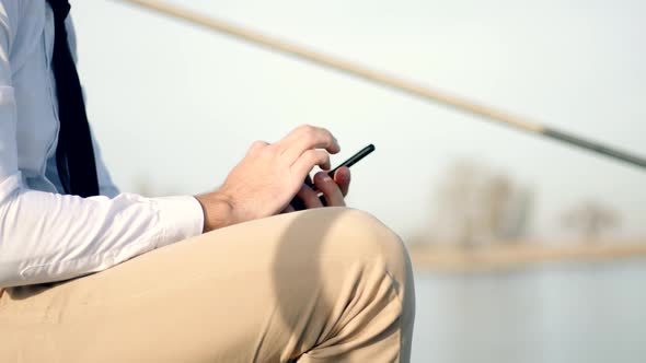 Man Looking At Cell Phone Using App And Browsing In Internet. Man Using Mobile Phone. alt