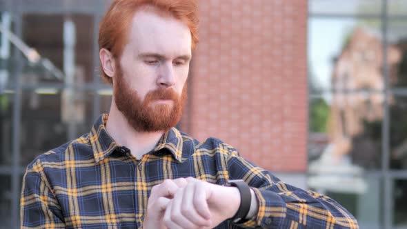 Redhead Beard Young Man Using Smartwatch Outdoor alt
