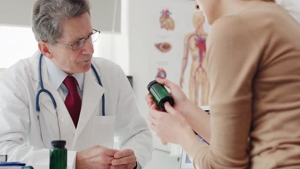 Handheld view of doctor giving woman the pills. Shot with RED helium camera in 8K alt