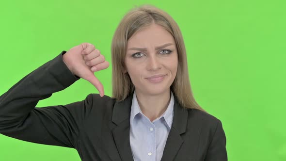 Attractive Businesswoman Showing Thumbs Down Against Chroma Key alt