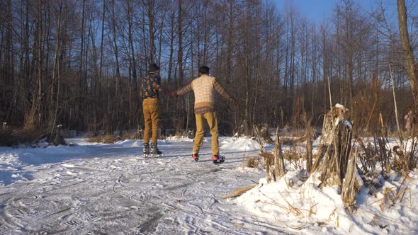 Two Indian and European Boys Learn To Skate on a Frozen Lake and Play Mischief