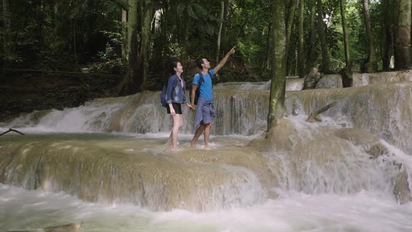 Couple Holding Hand And Walking At Waterfall alt