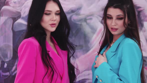Two Sexy Young Women Models in Pink and Blue Blazers Posing for the Camera alt
