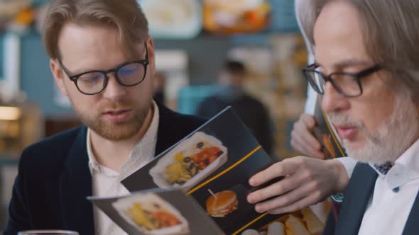 Business People Reading Menu and Ordering in Restaurant alt