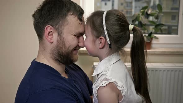 Young Man Plays with His Little Daughter alt