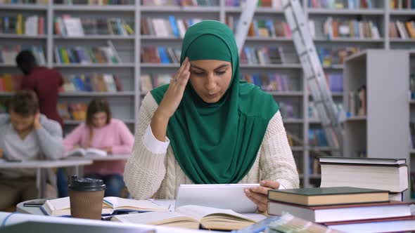 Tired Arab Female Student Suffering Headache alt