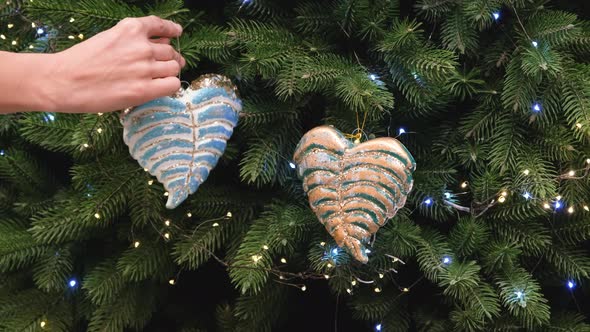 Female Hand Decorating Christmas Tree