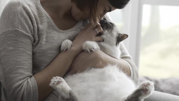 Woman petting her beautiful birman cat