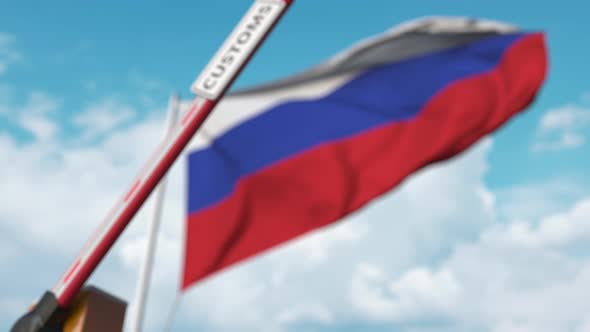 Barrier Gate with CUSTOMS Sign Being Closed at Flag of Russia alt