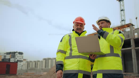 Foreman and Civil Engineers are Discussing Building Plan of New Object in Constructing Area alt