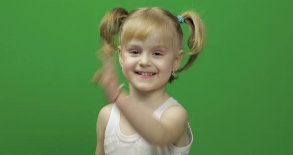 Happy Little Girl in White T-shirt. Cute Blonde Child. Dancing and Make Faces alt