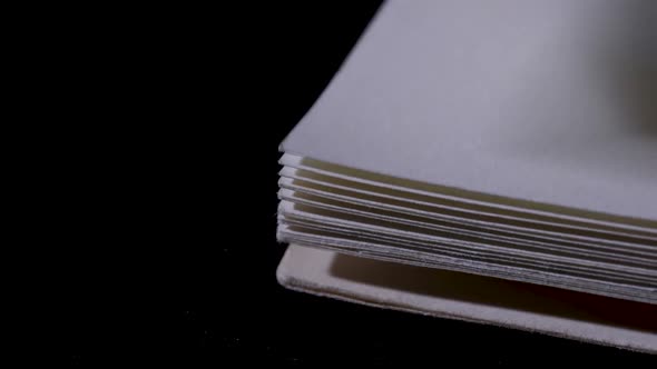 In a Dark Studio a Book is Laid and Opened on a Black Table the Pages are Turned From Beginning alt