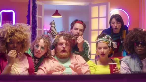 Trendy Sport Fans Watching TV Match at Home Party alt