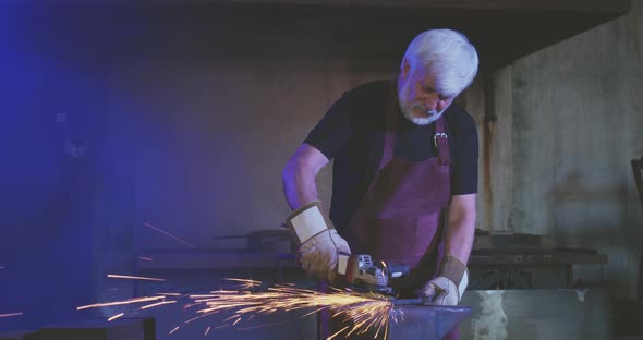 Old Man with Grey Hair Working As Blacksmith alt