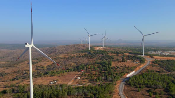 Aerial Shot of a Group of Wind Turbines in a Semidesert Environment alt