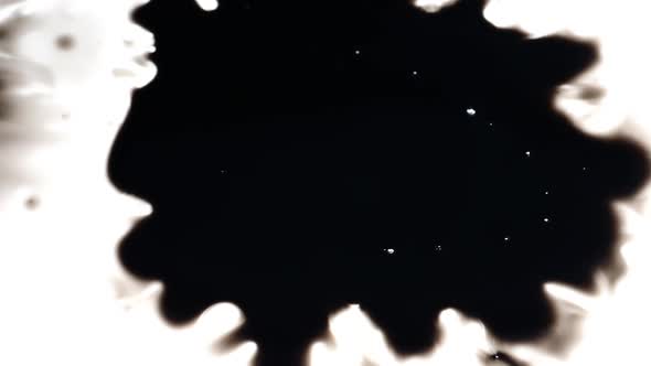 Ink blot spreading on white background alt