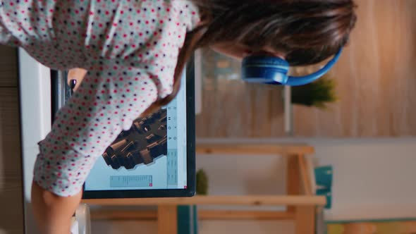 Vertical Video Architect with Headset Using Laptop Working at Home alt