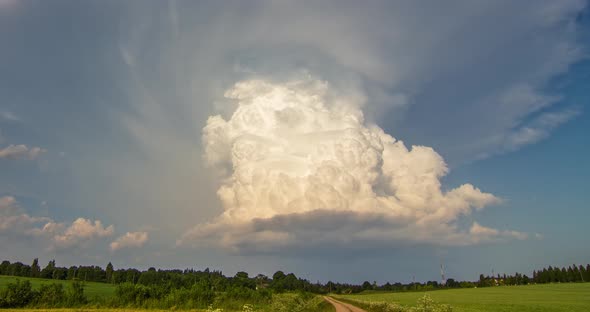 Isolated Thunderstorm White Cumulonimbus Clouds Tower Rising in the Evening Sky