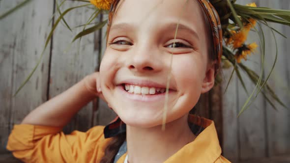 Portrait of Happy Little Girl in Flower Wreath alt