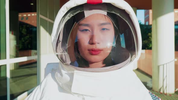 Close-up of Asian astronaut looking through helmet visor