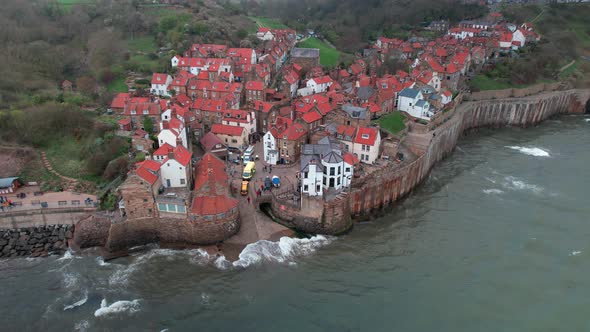 Static scenic Robin's hood bay landmark village resort houses aerial view at high tide alt