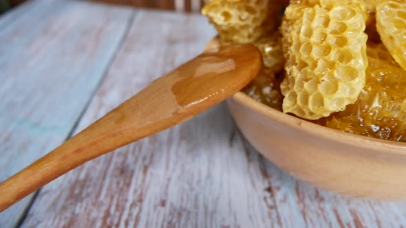 Honeycombs with Honey in a Plate on a Wooden Table