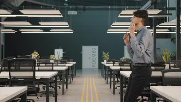 Excited Young Man Hispanic Arabian Employee Manager Entrepreneur Winner Walking in Modern Office alt