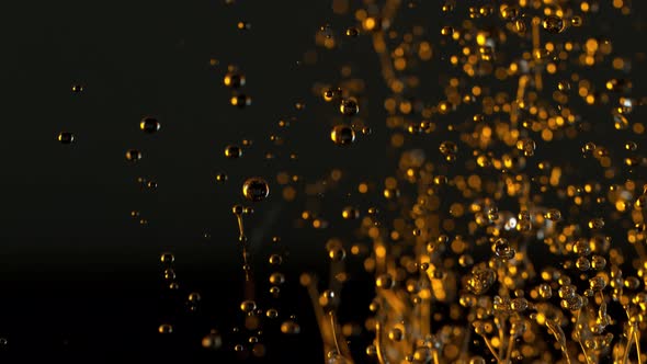 Super Slow Motion Shot of Splashing Oil Isolated on Black Background at 1000Fps alt