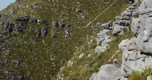 Young Caucasian woman zip lining alt