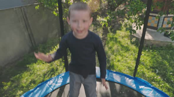Two Children Have Fun Jumping on a Trampoline