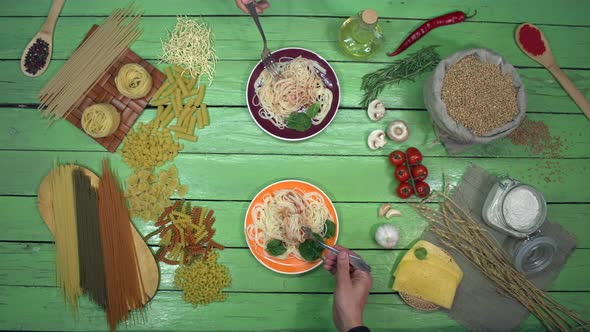 Tasting Spaghetti in colorful Plates on eco Table
