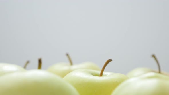 Healthy green apples with petals in group close-up 4K 2160p 30fps UltraHD tilting footage - Lot of o alt