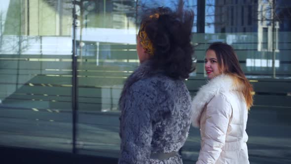 Two Girls Walk Down Street and Talk