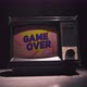 GAME OVER Title on a Tube TV Vintage 80's 90's Arcade. Zooming Out with Fog Giving a Retro Look at - VideoHive Item for Sale