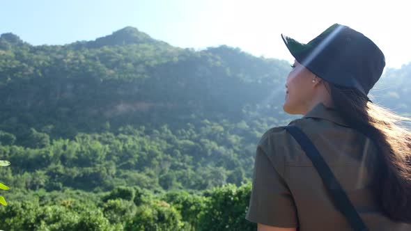 A female traveler looking at a beautiful mountain view