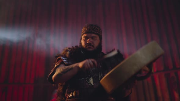 Man in Altai Clothes Plays Shamanic Drum at Fertility Ritual alt