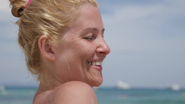 Woman sunbathing on the beach 3840X2160 UHD video - Blond Caucasian female enjoys on French coast  2